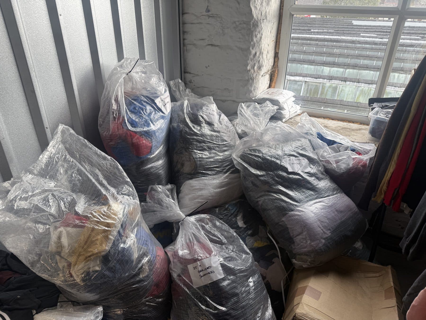 Bagged lots stacked against the window of the unit, ready for dispatch.